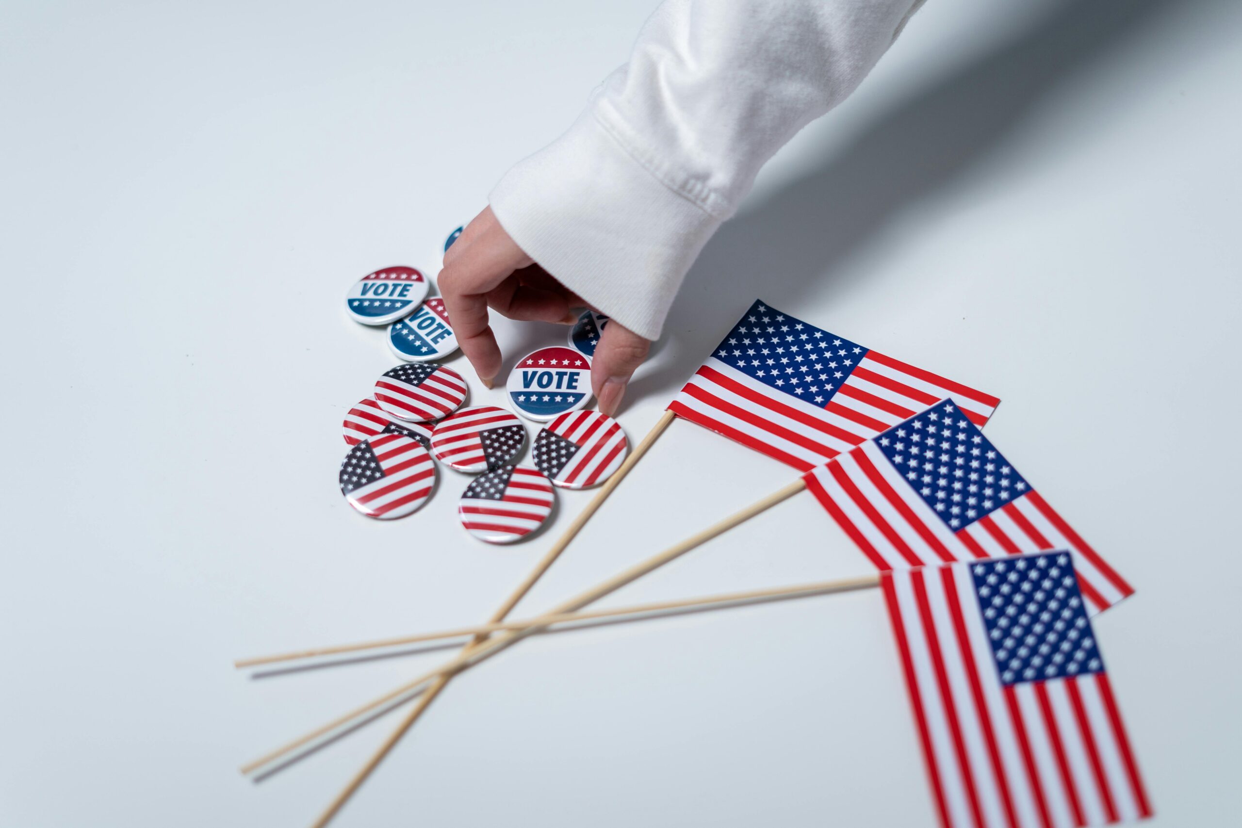 American Flags with a hand holding a vote sticker.