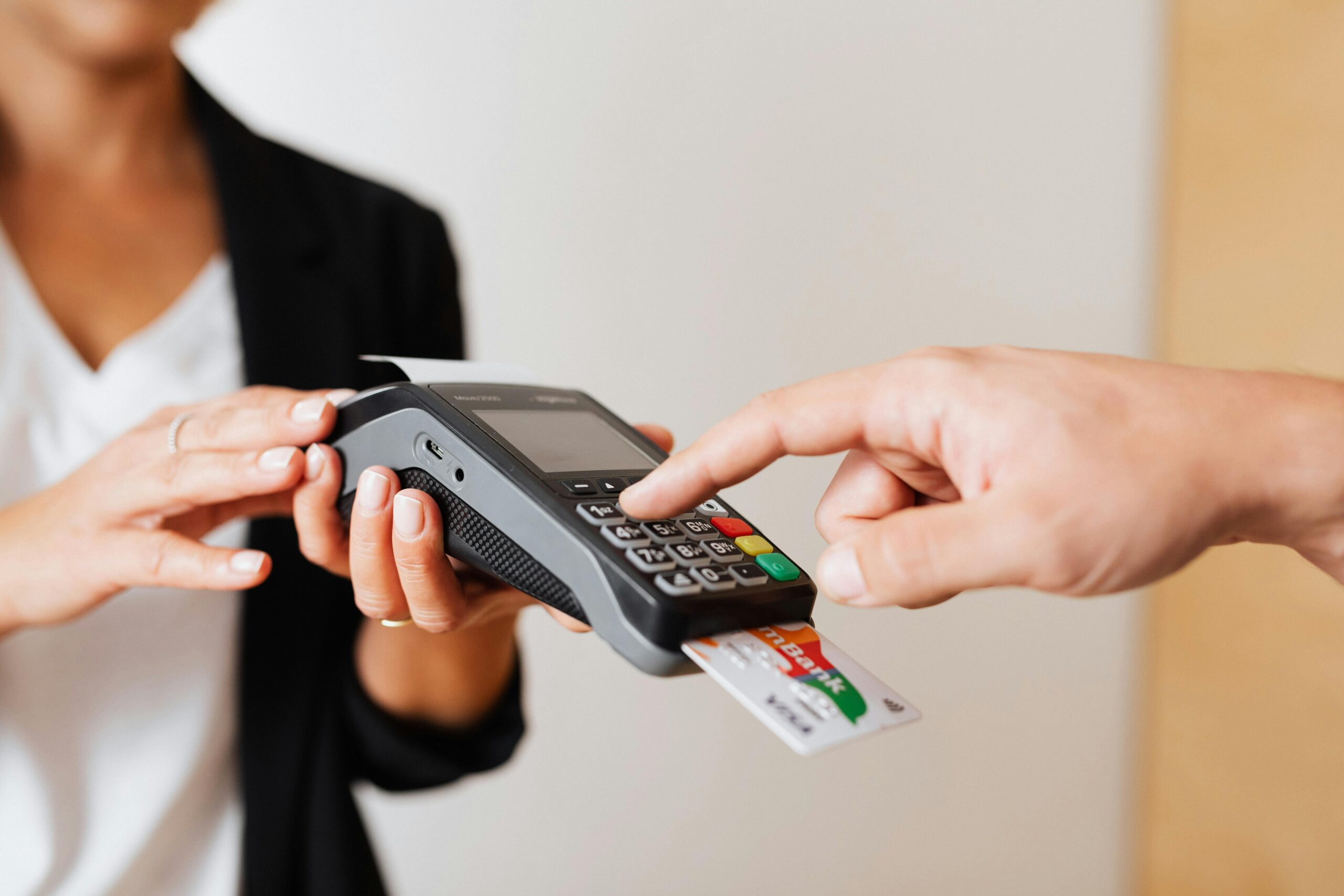 Two people using a credit card reader for a transaction.