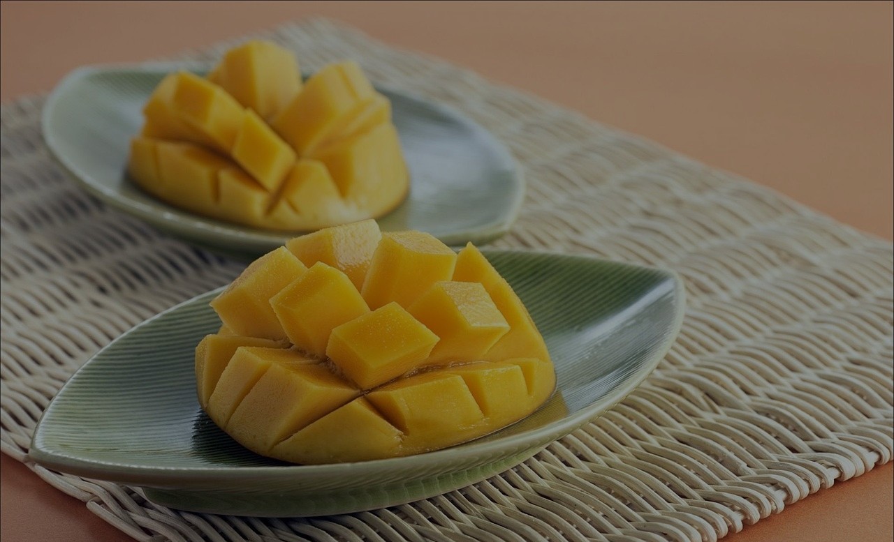 Cut up mangoes on a table.