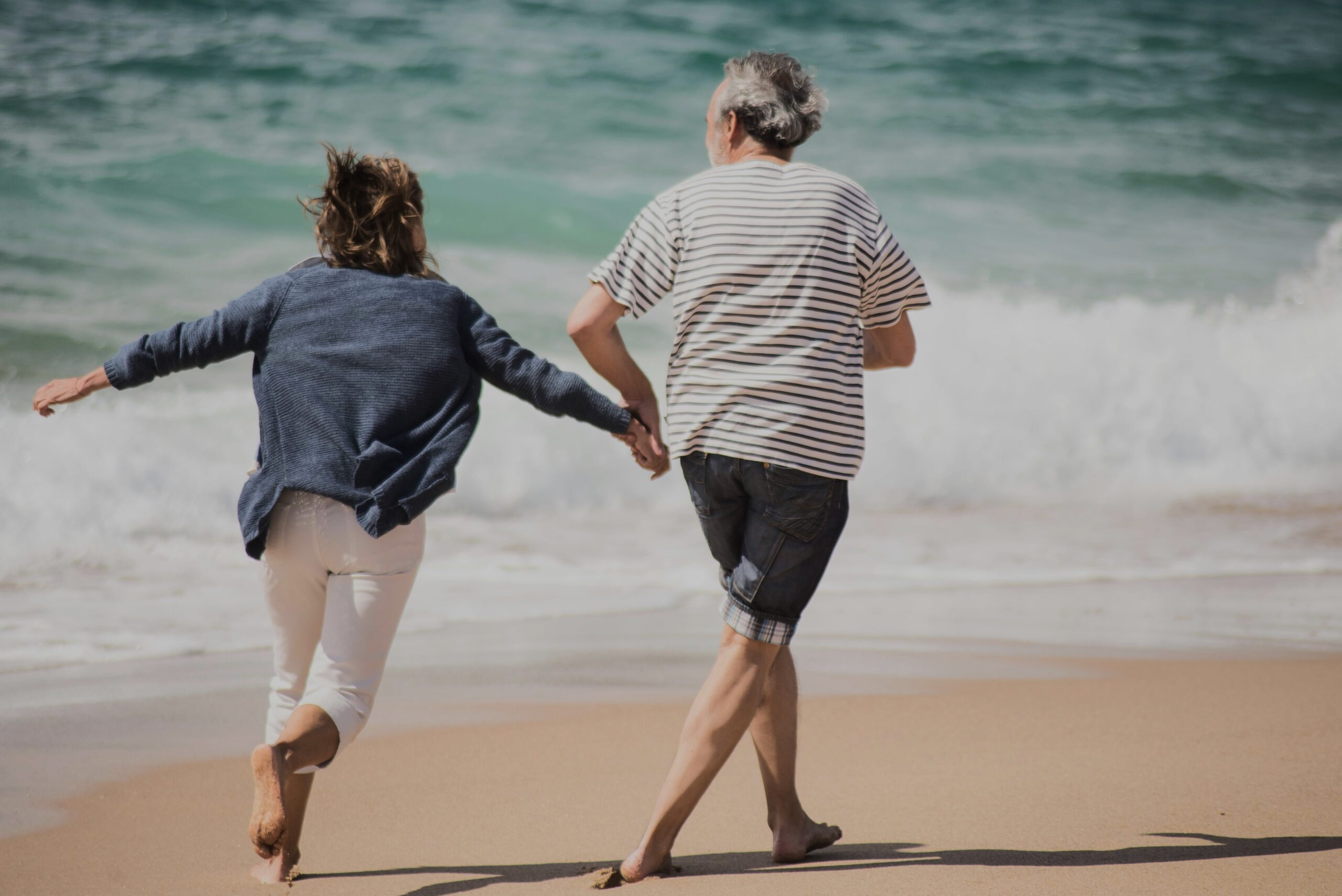 A photo of two active seniors at the beach.